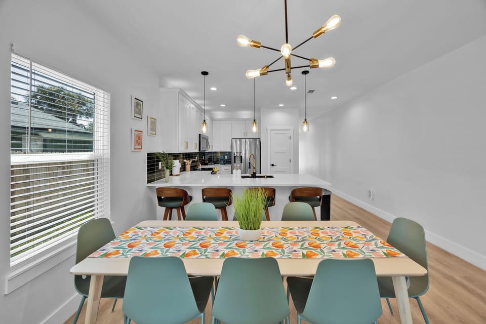 Dining Room #1 - table with seating for 8, kids table with seating for 4, high chair.