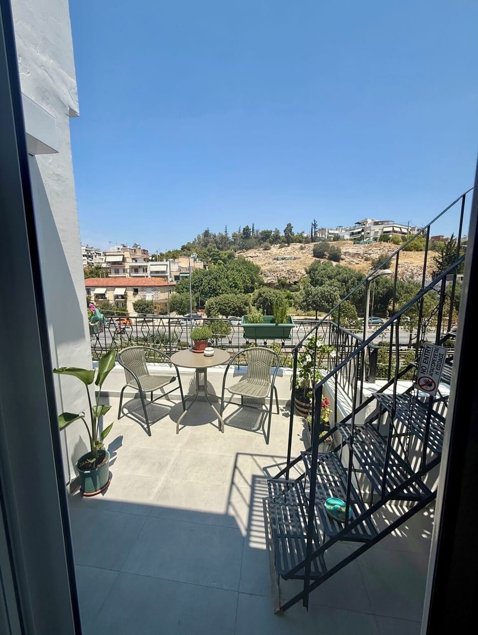 Private balcony with dining table and sunset views.