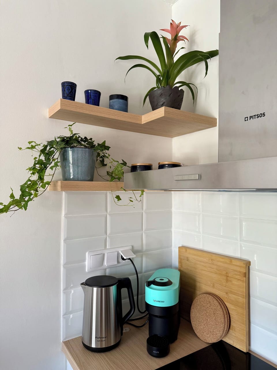 Fully equipped modern kitchen with oven, cooking essentials, and fridge, 