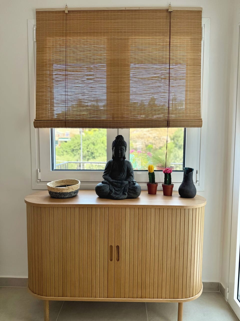 Cozy and bright bedroom equipped with boho and mindful decor, and cliff views.