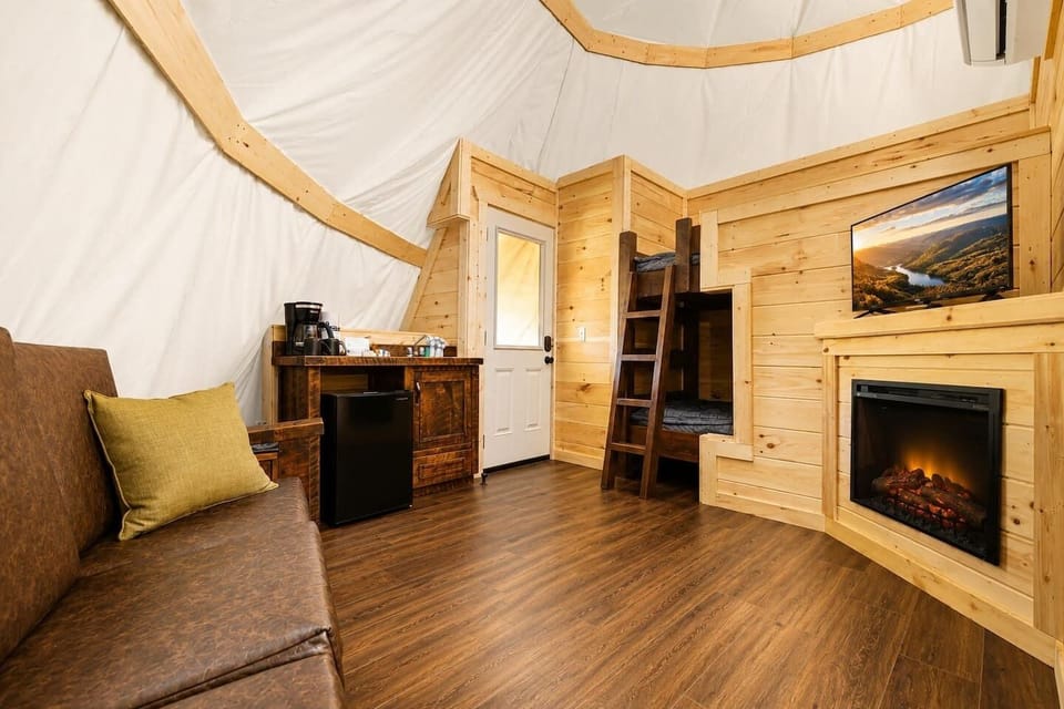 Cozy interior entrance and living space featuring rustic wood paneling.