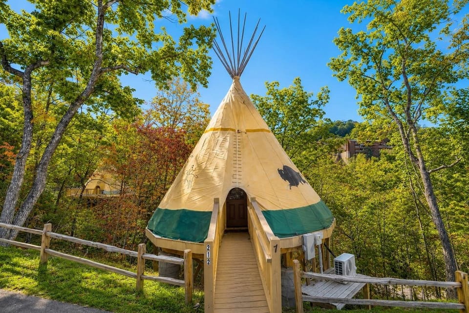 Beautiful daytime perspective of the unique teepee structure surrounded by lush.