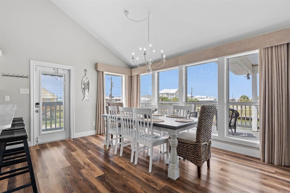 Gather around your spacious dining table with panoramic windows flooding the room with natural light and scenic views.