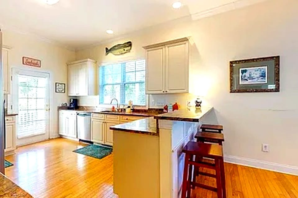 Fully equipped kitchen with granite counters, ample prep space and seating.