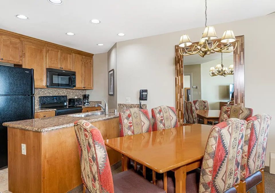 Fully equipped kitchen with full-size appliances, cookware, and a dining area that seats the whole group.