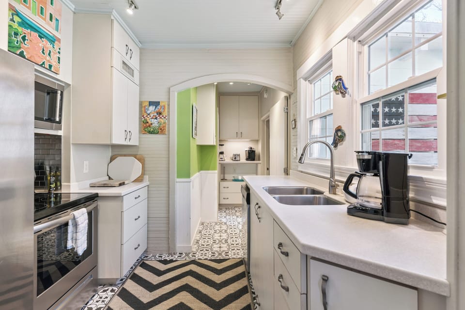 Your bright galley kitchen features everything needed for home cooking, from the modern appliances to the charming patterned floors that add character to your space.
