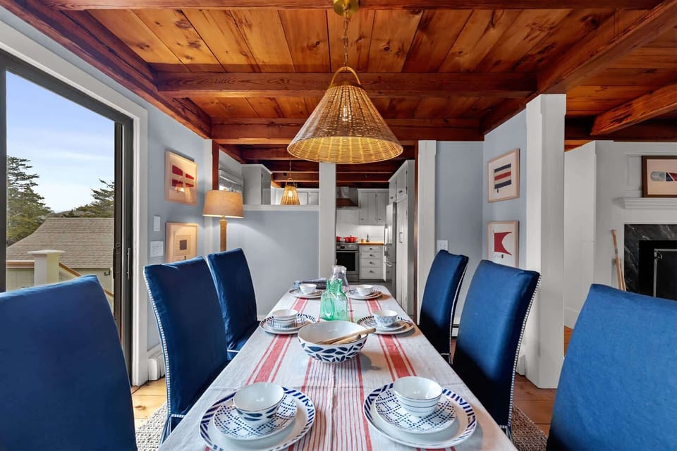 Gather for breakfast or dinner in this inviting dining area, thoughtfully styled with coastal colors and easy access to the kitchen.