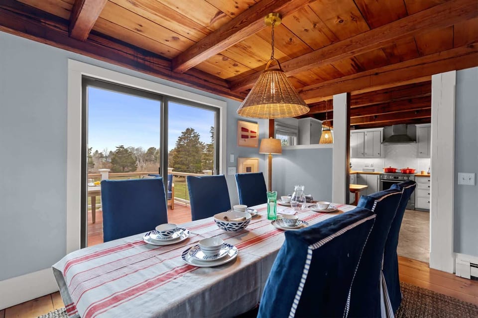Dining room opens toward the deck and kitchen, creating a bright and functional space for easy Cape Cod entertaining.