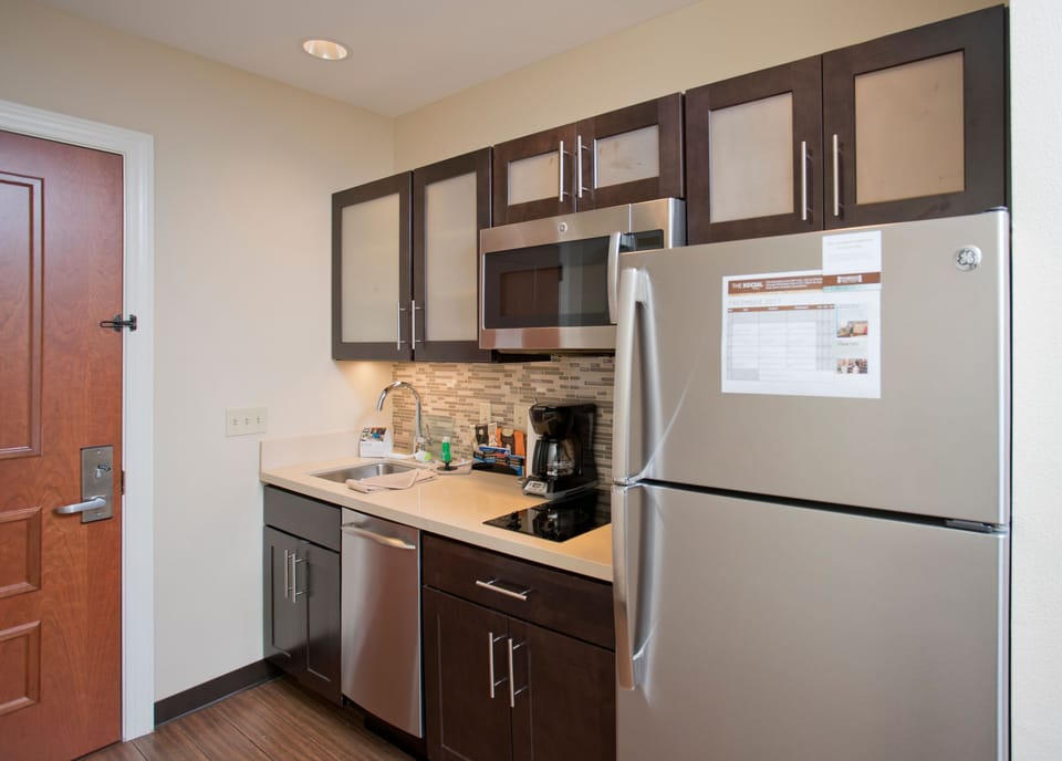 Contemporary kitchen featuring stainless steel appliances and ample storage.