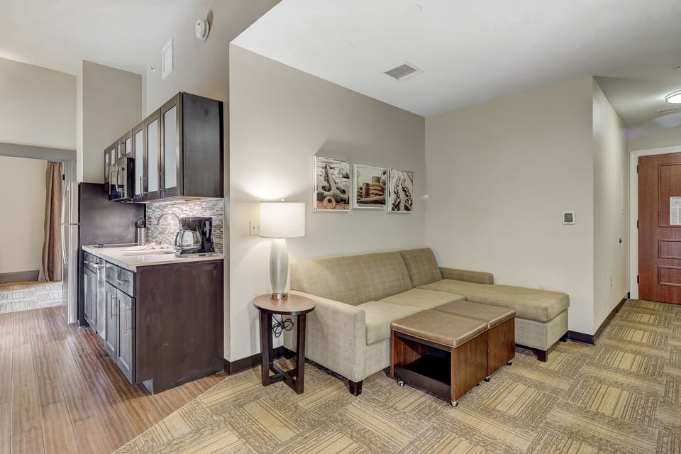 Inviting living area with a comfortable couch and kitchenette.