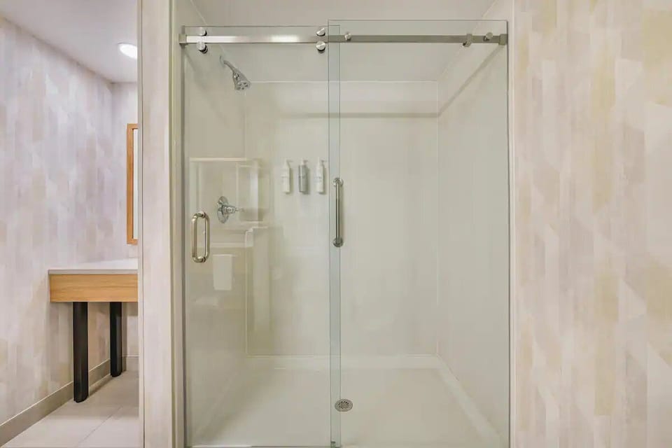Rinse off in the sleek glass shower with spa simplicity