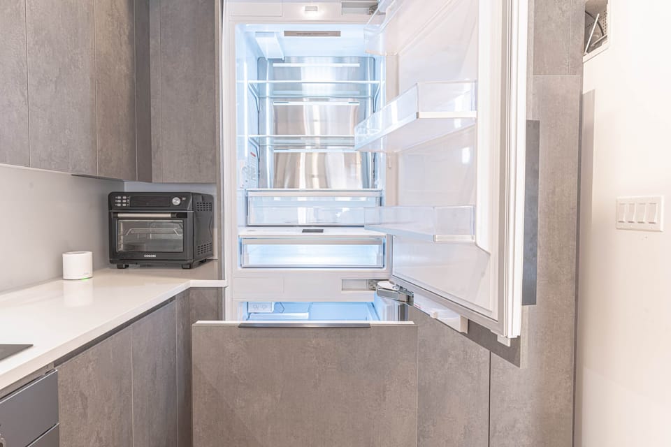 Full-size fridge with modern kitchen design and ample storage