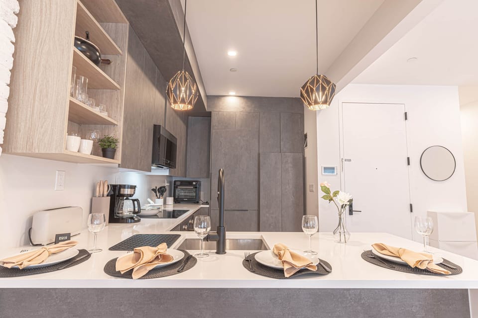 Modern kitchen island with seating and stylish pendant lighting.