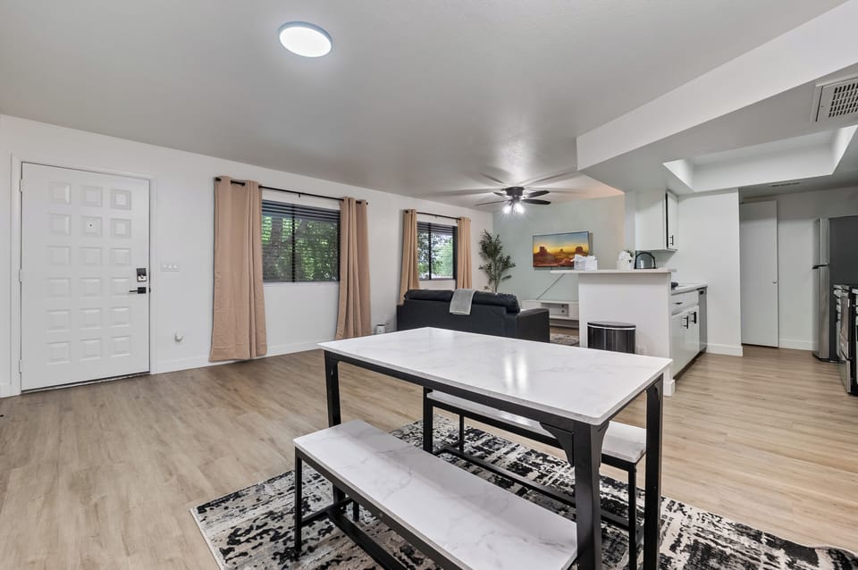 Spacious dining area with a modern table and bench seating, perfect for shared m