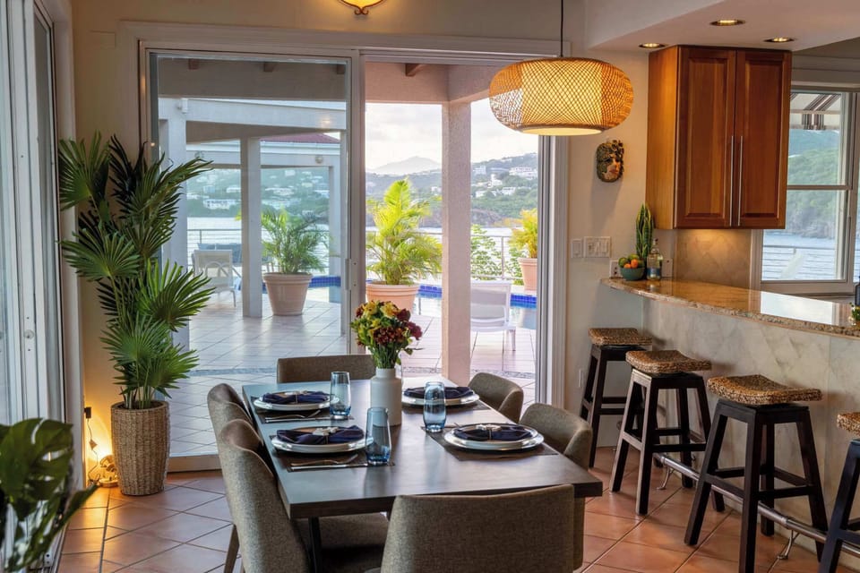 Breezy and inviting, this space opens directly to the pool and ocean beyond—perfect for laid-back breakfasts, lingering dinners, or sunset drinks. Natural textures and warm light create the perfect backdrop for island-style gatherings.