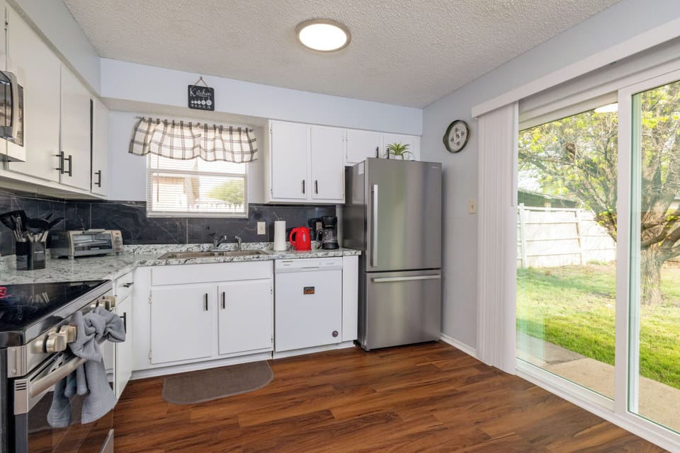 Modern kitchen with stainless steel appliances, all essentials.