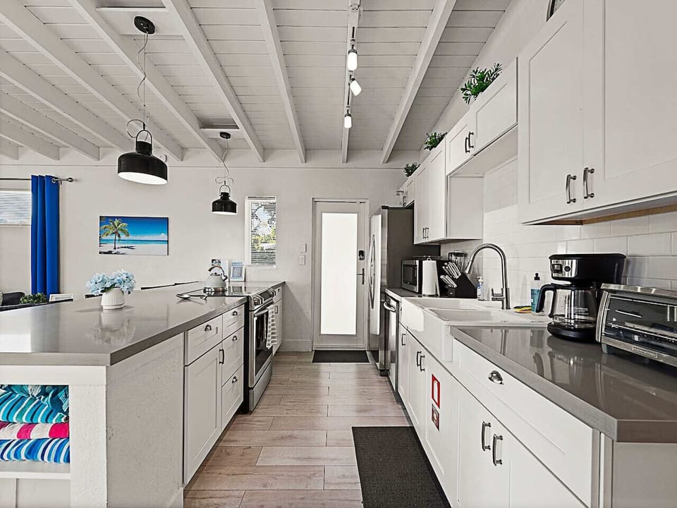 Culinary Hub: Boasting a functional counter and custom cabinetry. Enjoy a dedicated space where the family can gather and chat while you cook.