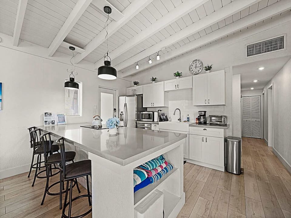 Gourmet Kitchen: Features a central breakfast bar and premium stainless appliances. The perfect spot for a quick morning coffee or casual meal.
