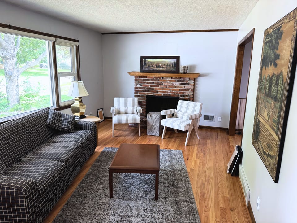 Bright, open living space with large windows and a clean, welcoming layout.