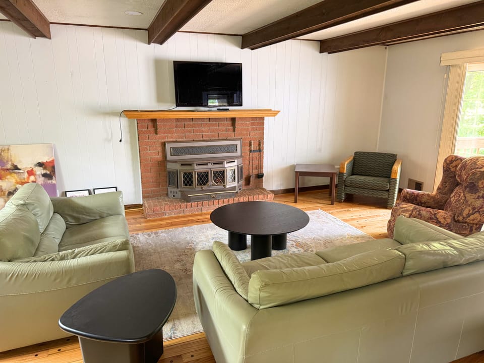 Warm living room with brick fireplace and cozy gathering space.