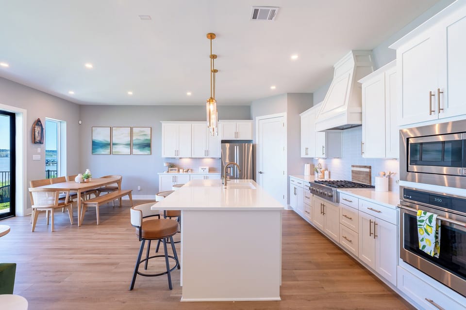 Modern kitchen with a large island, bar seating, and stainless steel appliances