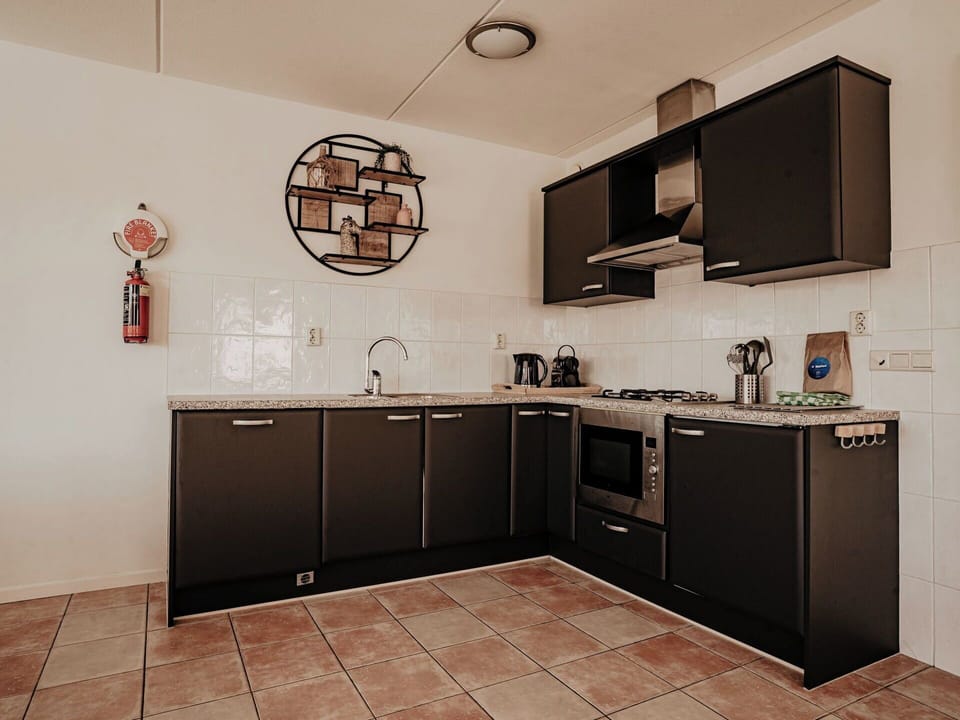 Kitchen, Countertop, Kitchen Appliance, Major Appliance, Interior Design, Cabinetry, Flooring, Furniture, Kitchen Stove, Lighting