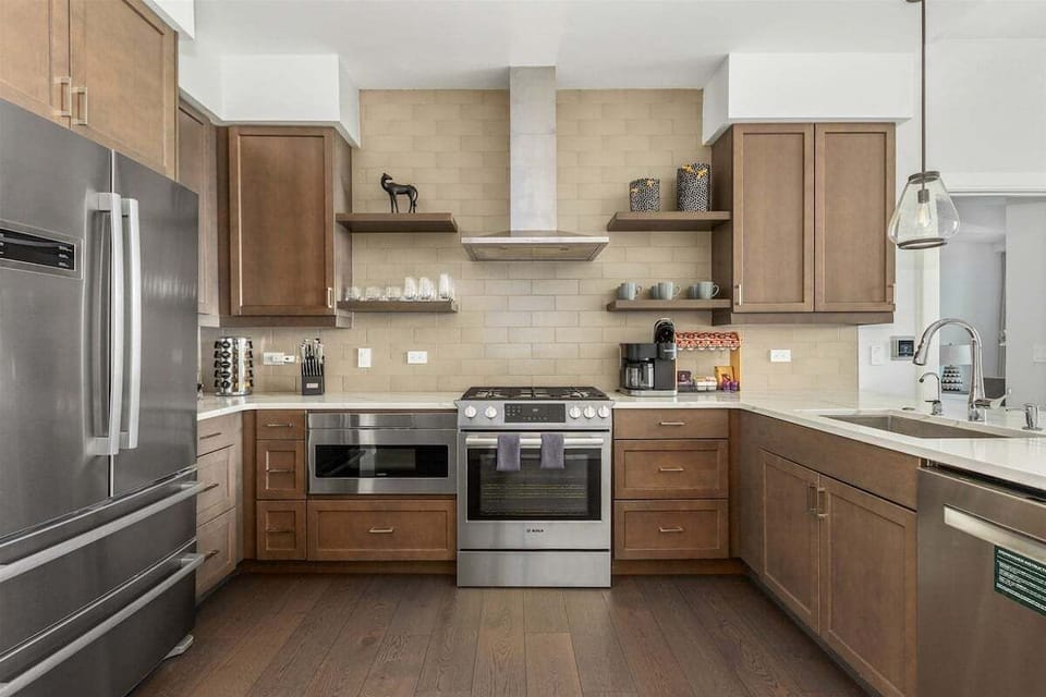 Kitchen with 5 burner gas stove, dishwasher, microwave, Keurig Duo and refrigerator