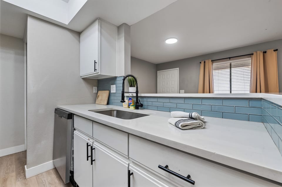 Practical kitchen setup with a tidy sink and generous counter space, ideal for p