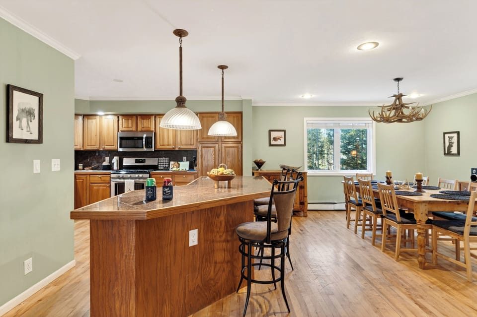 View of the kitchen cabinetry and prep space leading toward the dining area.