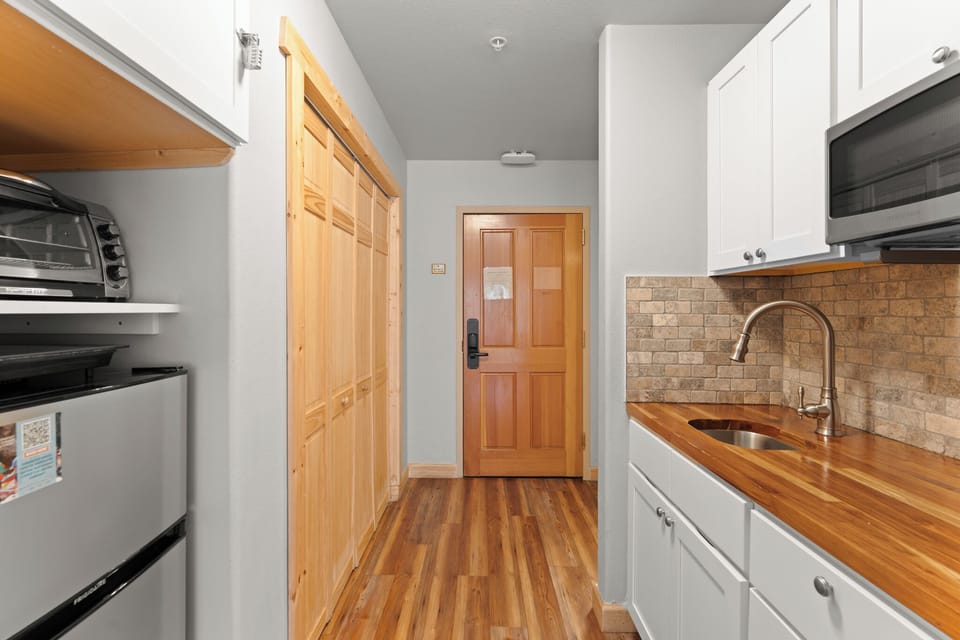 Kitchenette with microwave, toaster oven, and mini fridge.