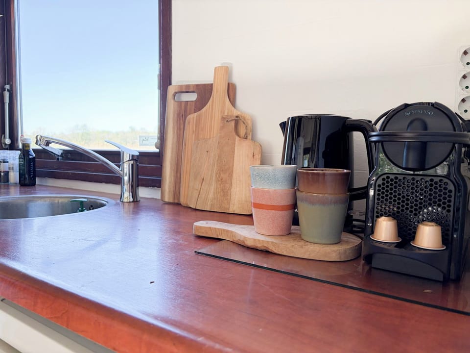 Coffee corner in your tiny stay Netherlands for a relaxed morning — complete with coffee, tea, and the essentials you need to start your day right. Enjoy a slow, cozy moment in a thoughtfully designed space that keeps things simple, warm, and perfect