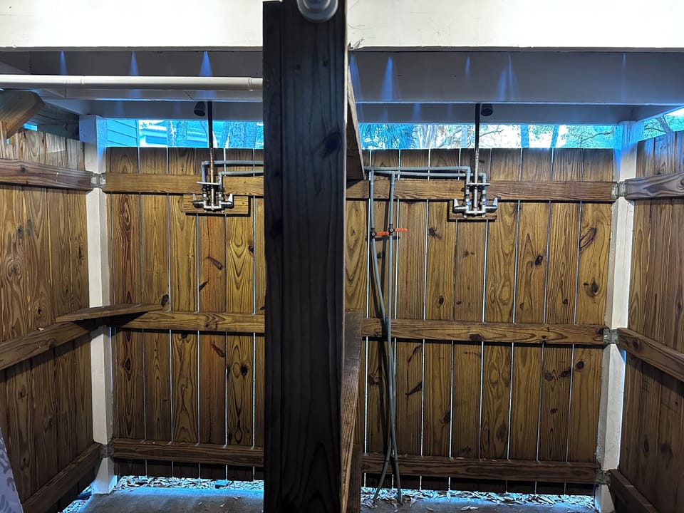 Outdoor showers under back deck