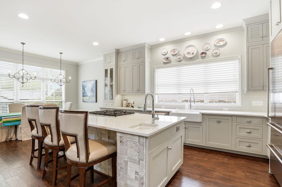 1129 Peachtree - Kitchen - White and gray Shaker cabinets, marble countertops, and a central island with bar seating — a kitchen built for real cooking.