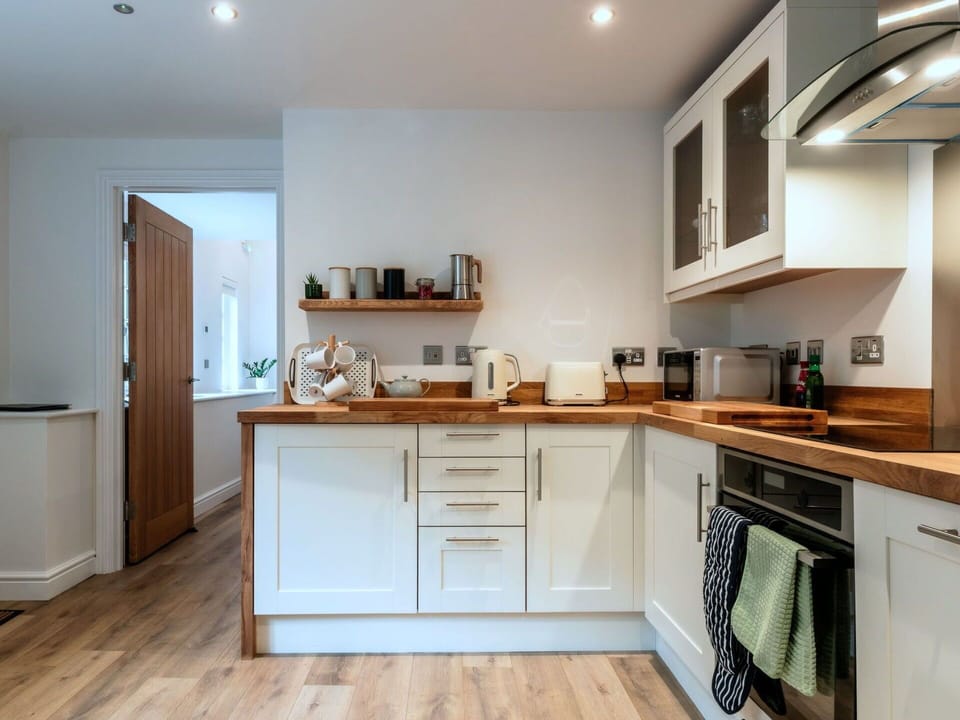 Furniture, Countertop, Interior Design, Cabinetry, Kitchen, Flooring, Kitchen Appliance, Wood, Major Appliance, Home Appliance