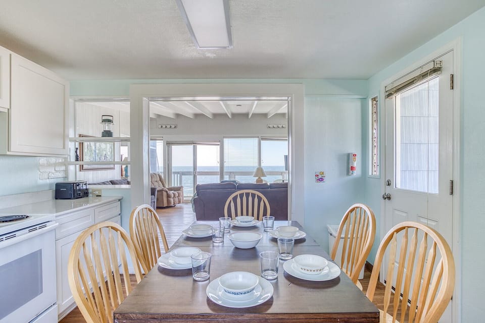 Your coastal dining room opens to an ocean-view living area, where morning coffee and seaside meals become cherished memories.