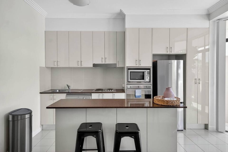 Start your morning at the kitchen island with bar seating, a casual spot for coffee or conversation before heading out.