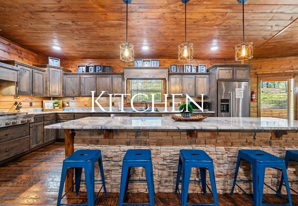 The kitchen island is the perfect gathering spot, offering bar seating and plenty of space for prepping meals or sharing a drink.