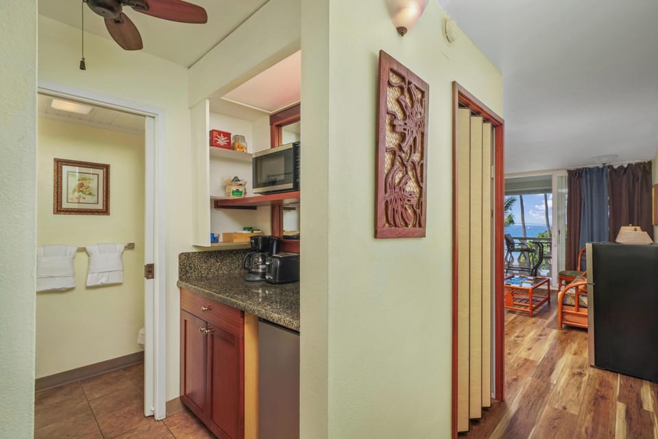 Your tropical retreat features a well-equipped kitchenette with granite counters and ocean views beckoning from your private living space.