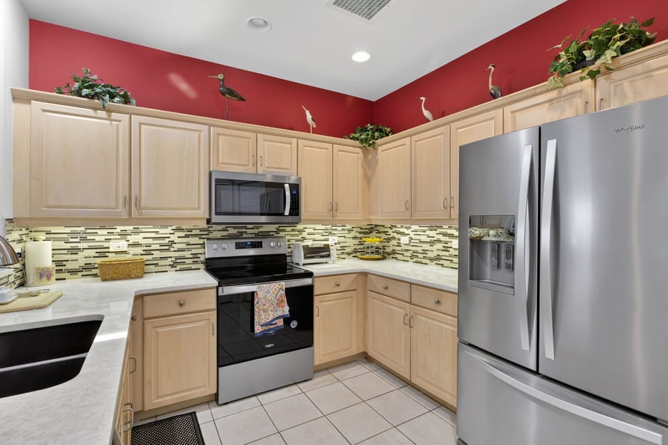 Fully equipped kitchen with stainless steel appliances and ample counter space.