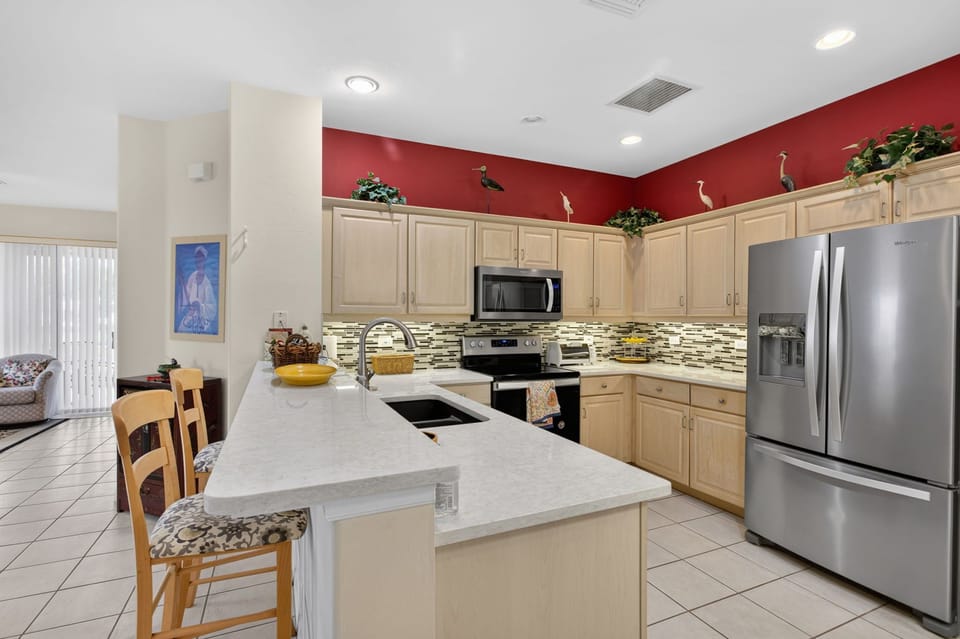 Fully equipped kitchen with stainless steel appliances and spacious countertops.