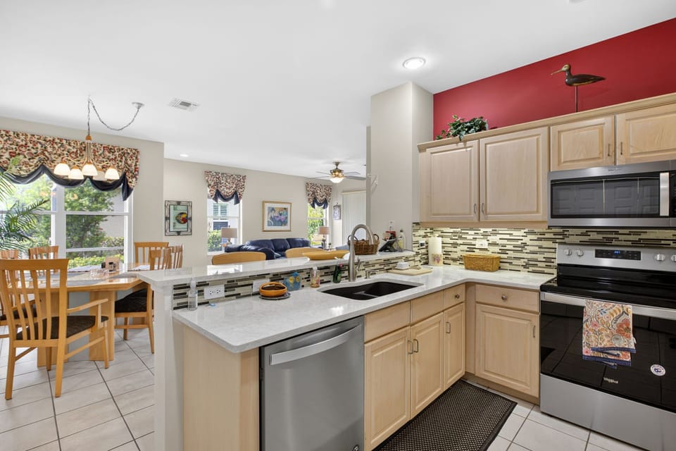 Kitchen features modern appliances, and opens to a bright dining area.