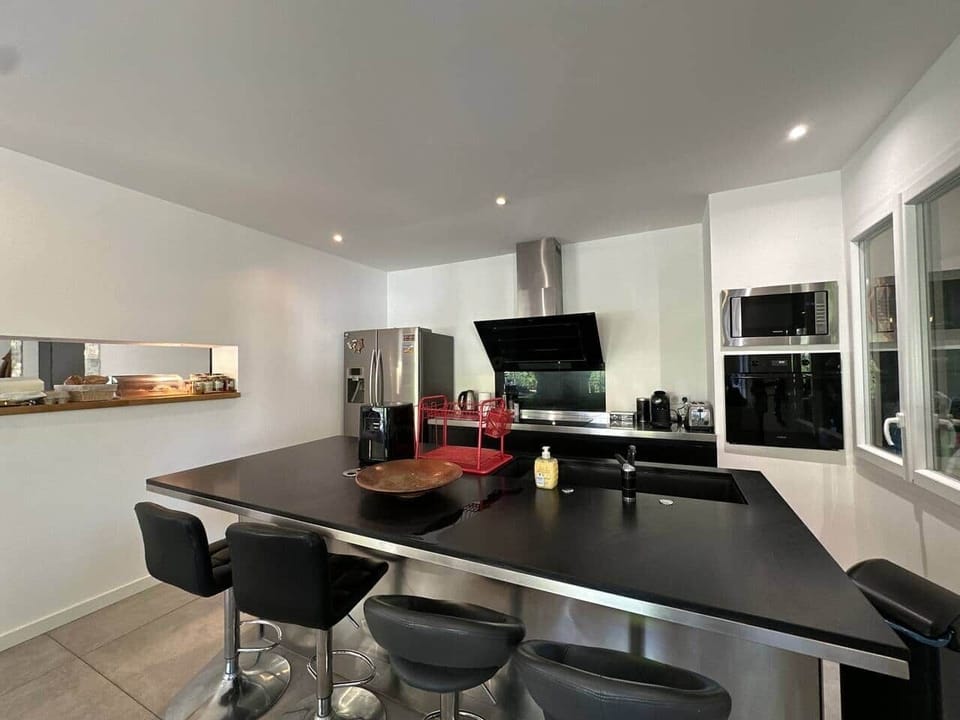 kitchen, fridge, oven, microwave, coffee machine, kettle, toaster, dining table