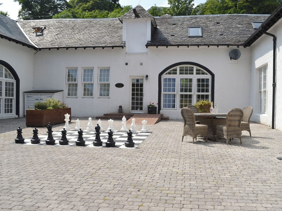 Characterful courtyard with outdoor chess game | Marjorie&rsquo;s Cottage - Home Farm, Glendaruel