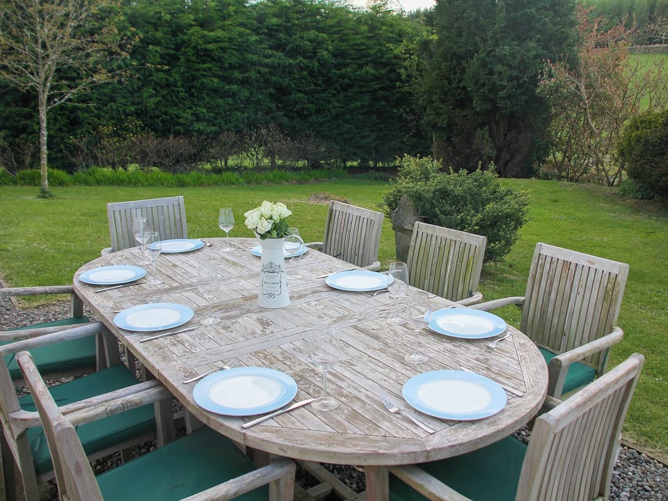 Lawned garden with large table and chairs for alfresco dining | Diamonds Laggan - Barwhillanty Estate, Parton, near Castle Douglas