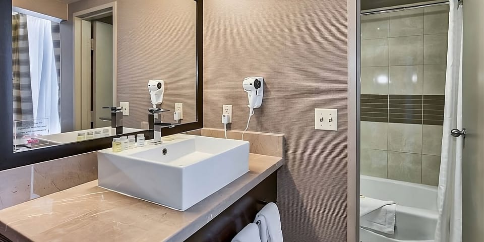 Refresh comfortably with a sleek vanity and bright, clean bath.