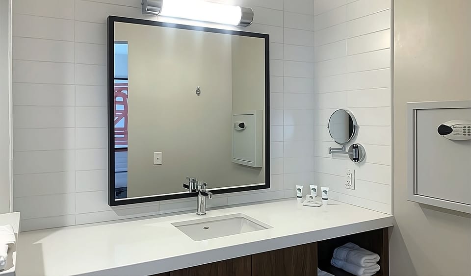 Refresh effortlessly at the sleek vanity with bright mirror lighting.