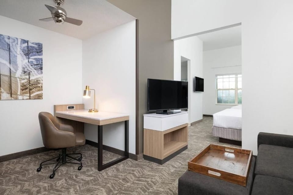 Settle into your spacious suite with desk, TV, and comfort.