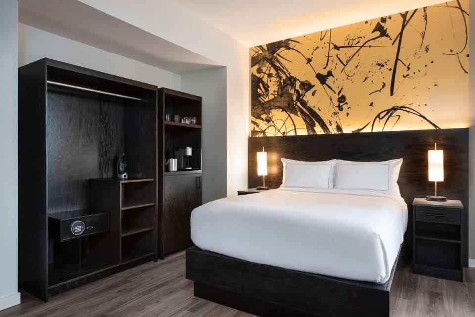 Recharge in a serene king bed with warm, ambient glow.