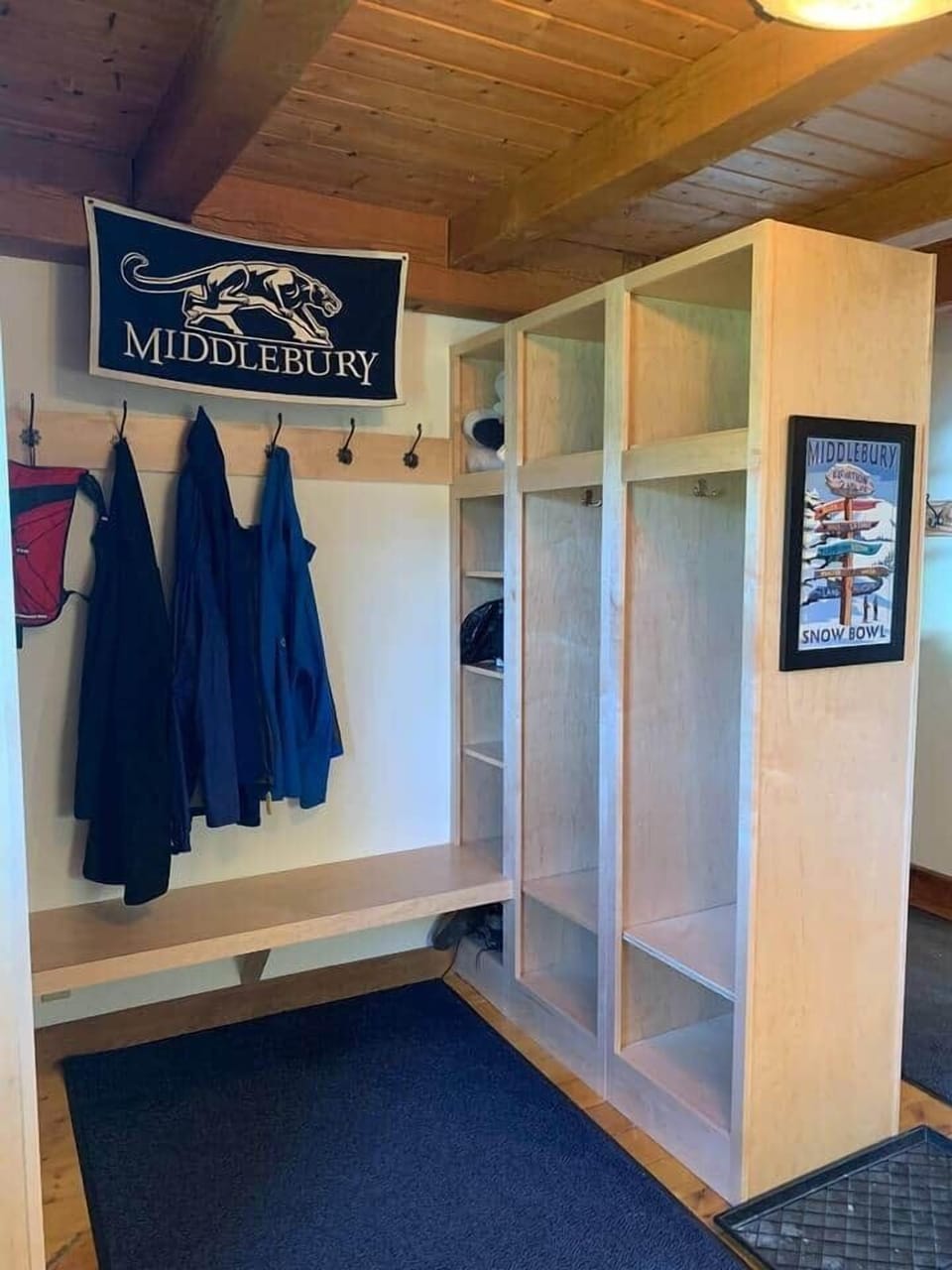 Mudroom with maple lockers, bench, and wash area, attached to kitchen