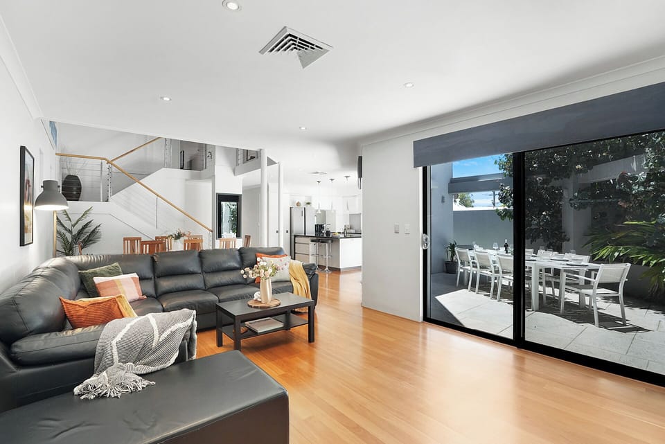 Open-plan living room seamlessly connected to kitchen, dining, and alfresco spaces.